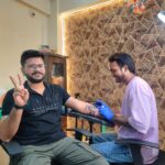 Tattoo shops in Surat – artist making band tattoo, smiling client